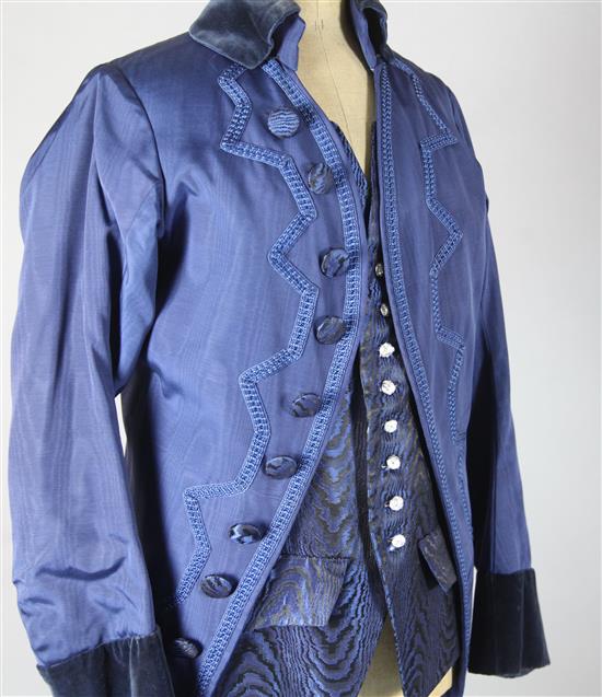 Cosi Fan Tutte: A rail with a blue and green, turquoise and green, gold and orange dresses, a blue velvet trimmed